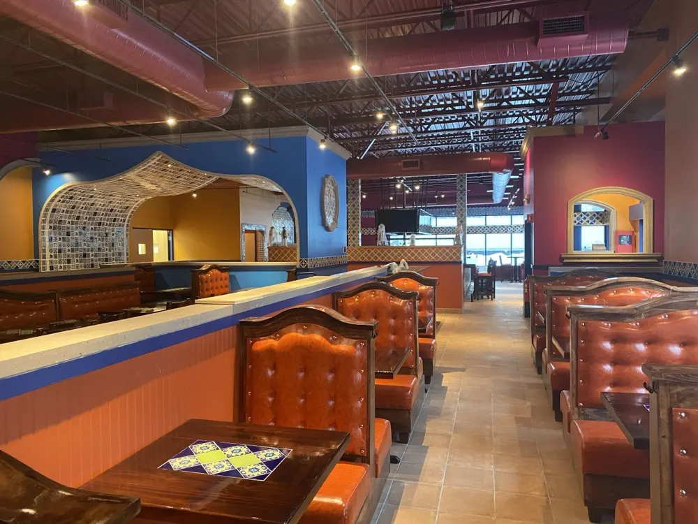 Colorful dining room with leather booths and tiled tables